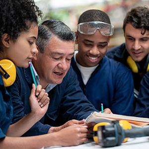 Teacher talking to a group of industrial design students stock photo